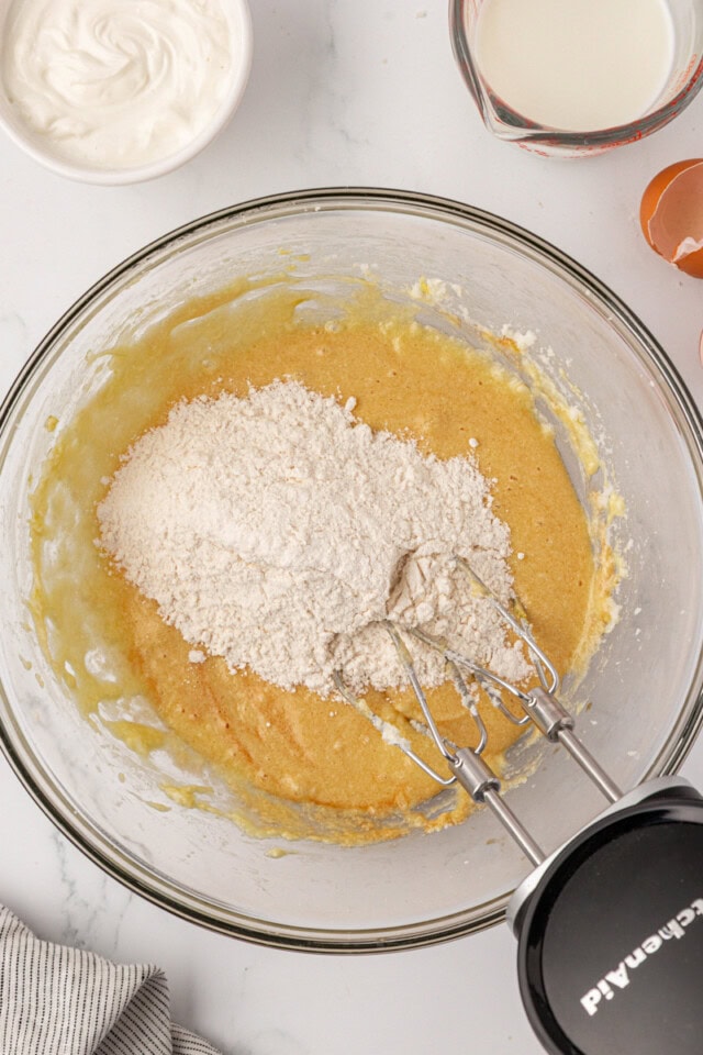overhead view of dry ingredients added to wet ingredients for cookies and cream cupcakes