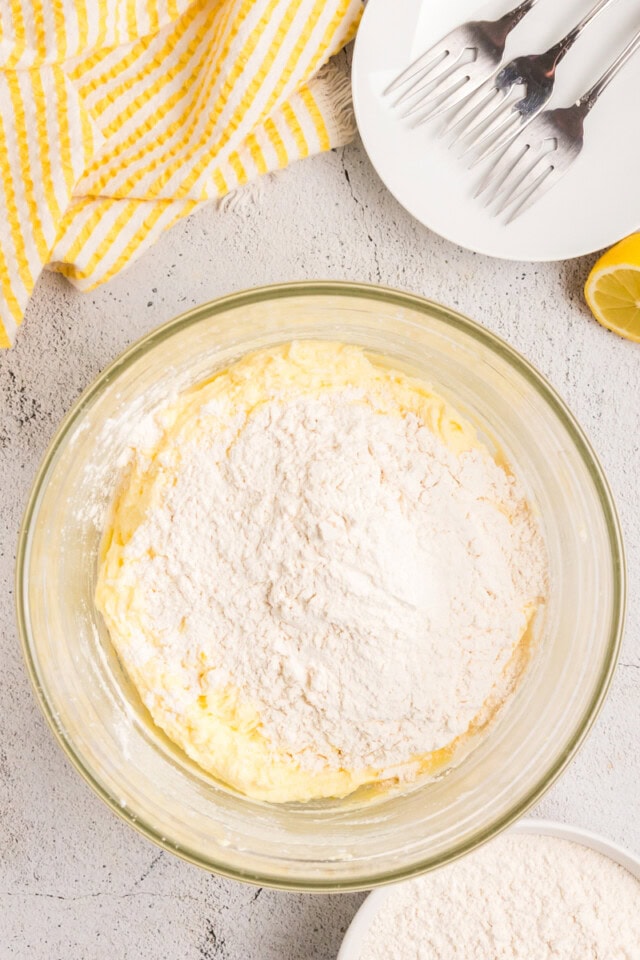 overhead view of dry ingredients added to lemon cake batter