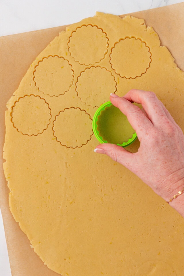 overhead view of lemon shortbread cookie dough being cut into rounds