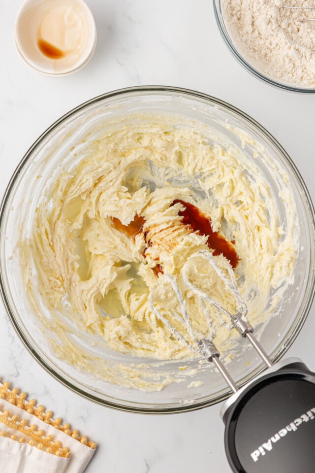 overhead view of lemon juice and vanilla added to creamed butter and sugar