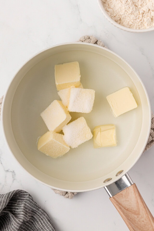 overhead view of butter, water, sugar, and salt in a saucepan