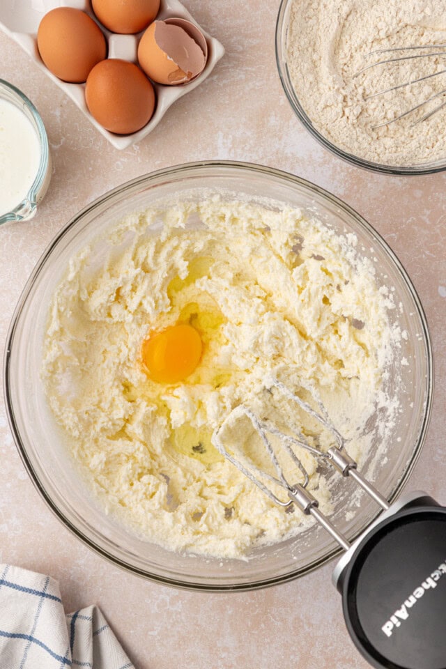 overhead view of egg added to creamed butter and sugar