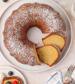 overhead view of partially sliced buttermilk pound cake topped with powdered sugar