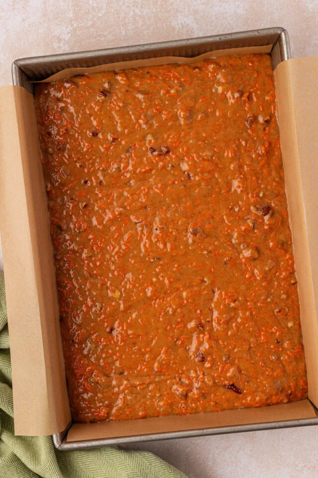 overhead view of carrot cake batter spread in a 9x13 baking pan