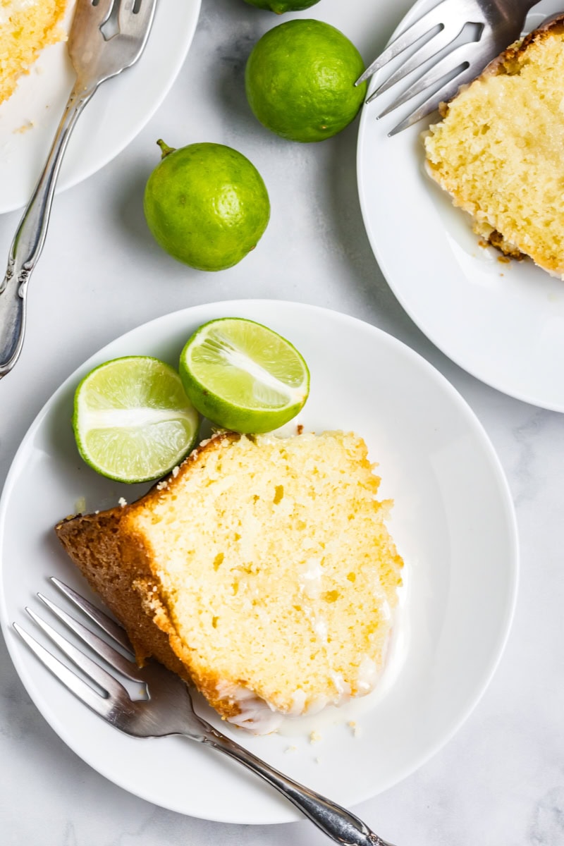 overhead view of a slice of Key lime Bundt cake on a white plate