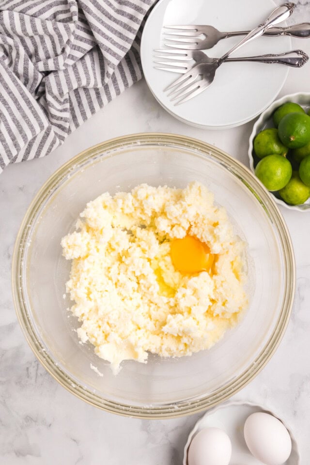 overhead view of egg added to creamed butter and sugar