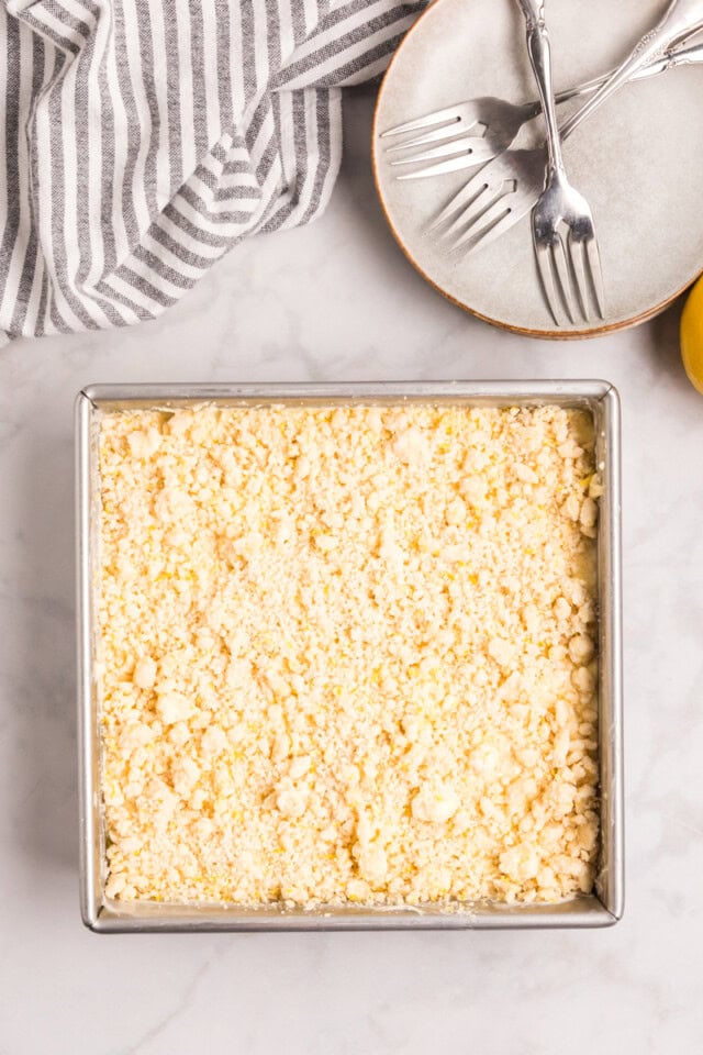 overhead view of lemon cream cheese coffee cake topped with crumb mixture, ready to go into the oven