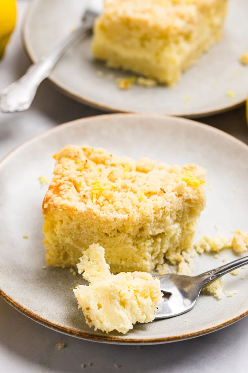 a slice of lemon cream cheese coffee cake with a bite on a fork