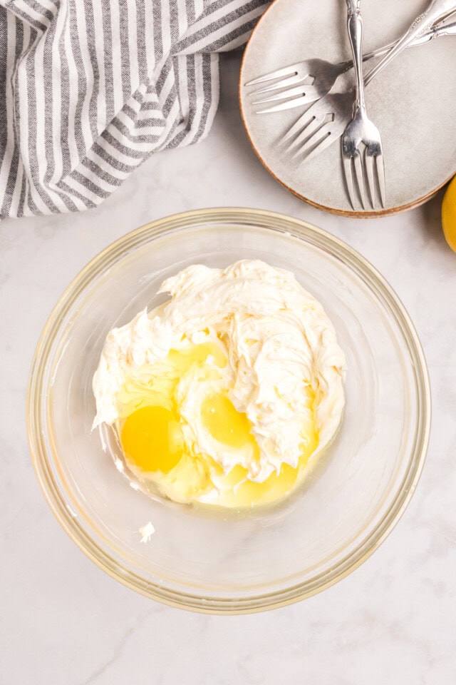 overhead view of egg and lemon juice added to beaten cream cheese and sugar
