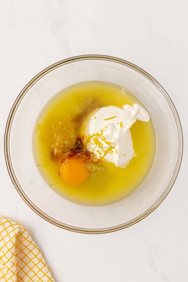 overhead view of wet ingredients for lemon muffins in a mixing bowl