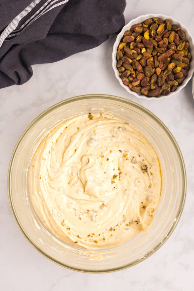 overhead view of pistachio cake batter in a mixing bowl