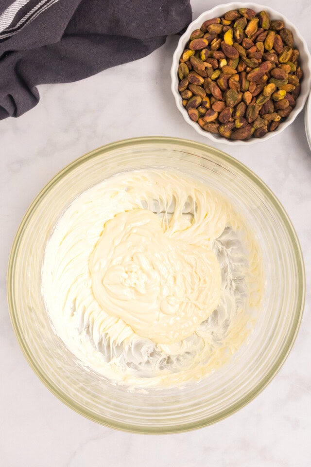 overhead view of melted white chocolate added to creamed butter