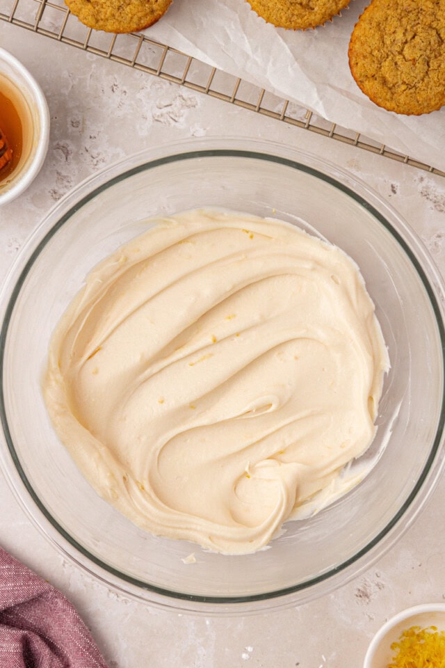 overhead view of honey cream cheese frosting in a mixing bowl