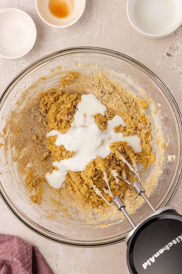 overhead view of buttermilk added to pistachio cupcake batter