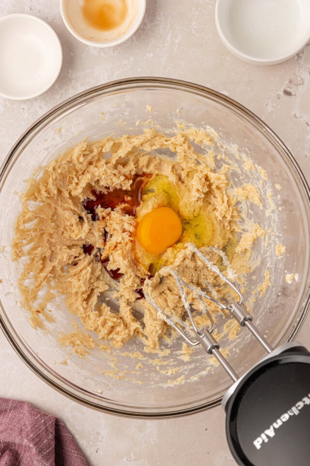 overhead view of egg and extracts added to creamed butter and sugars