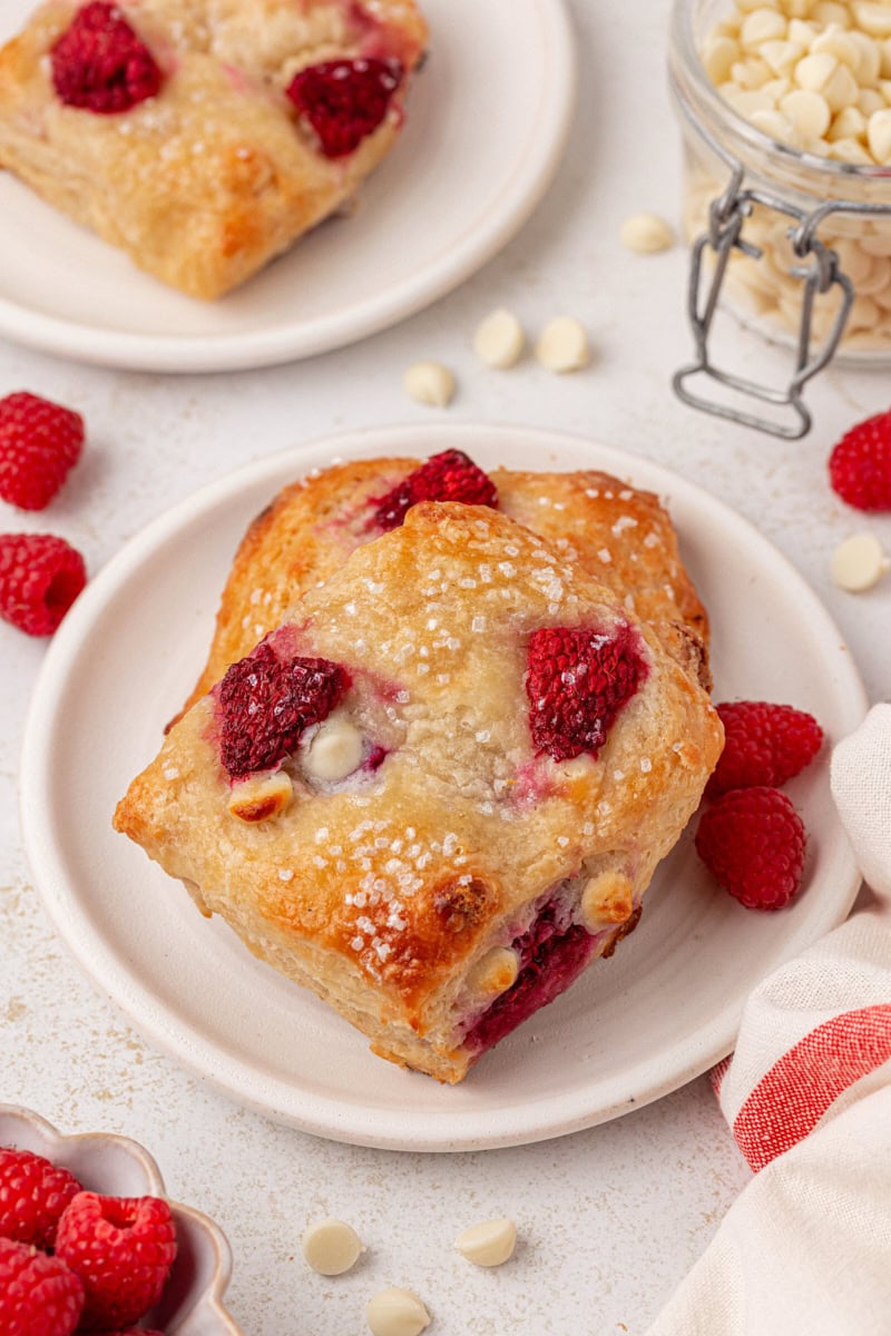 rustic raspberry white chocolate scones on a white plate