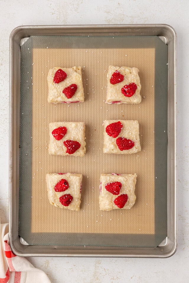 unbaked raspberry white chocolate scones on a baking sheet