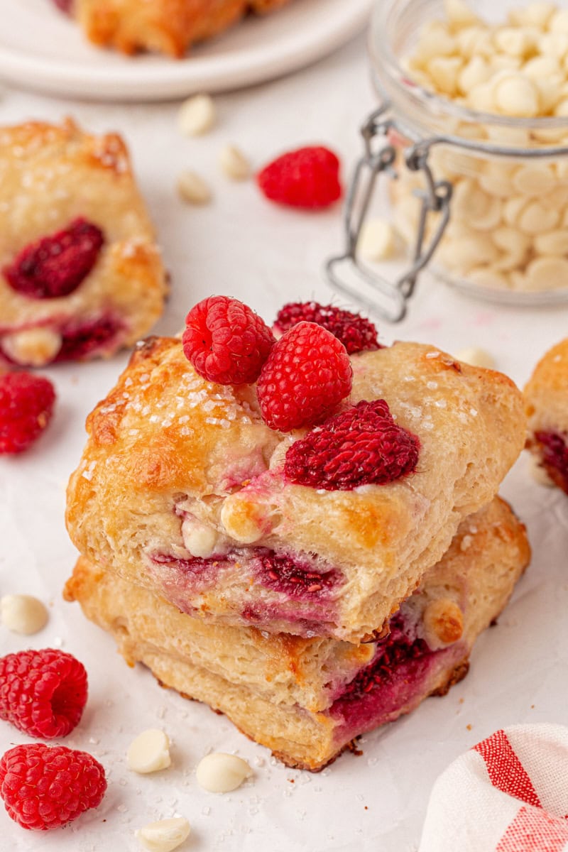 stack of two homemade white chocolate raspberry scones with coarse sugar topping