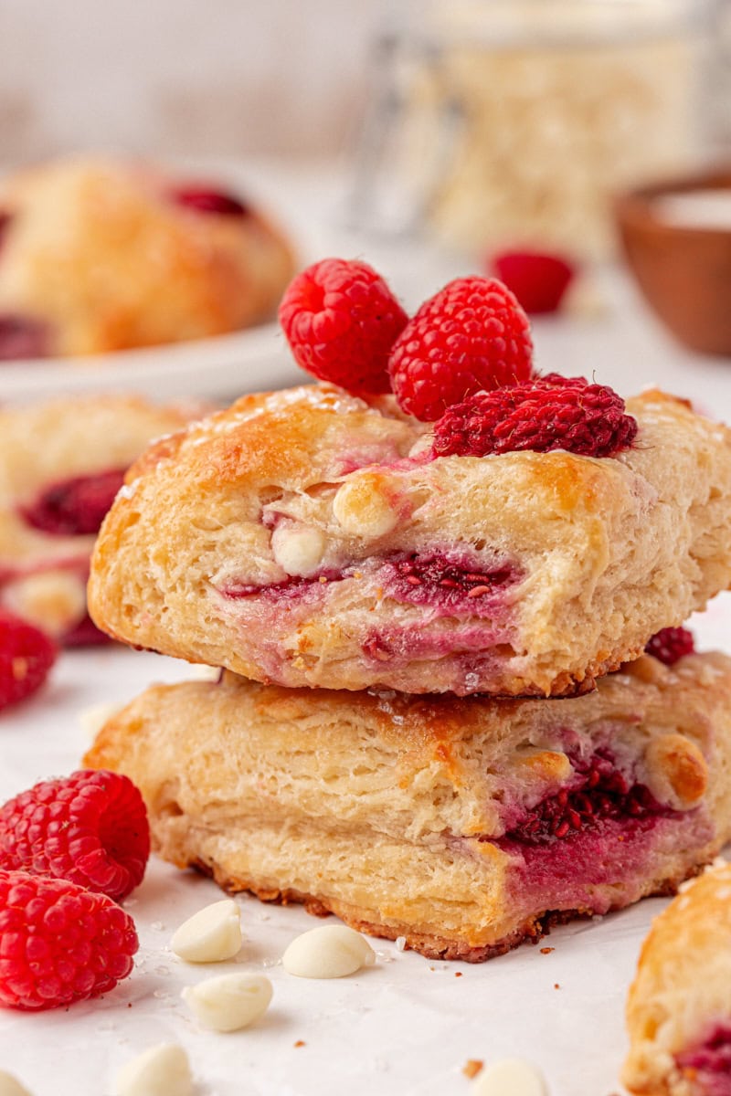 bakery-style white chocolate raspberry scones topped with fresh raspberries and coarse sugar