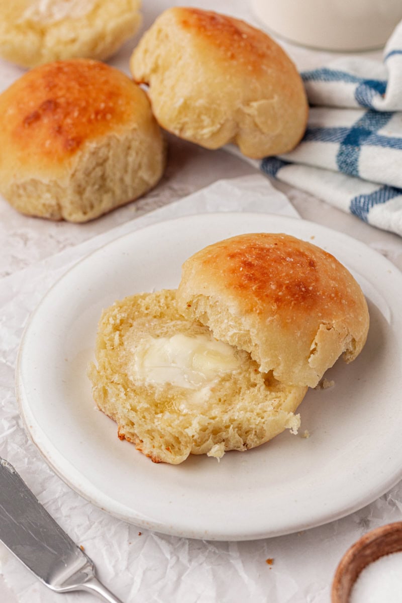 a warm dinner roll split in half and spread with butter