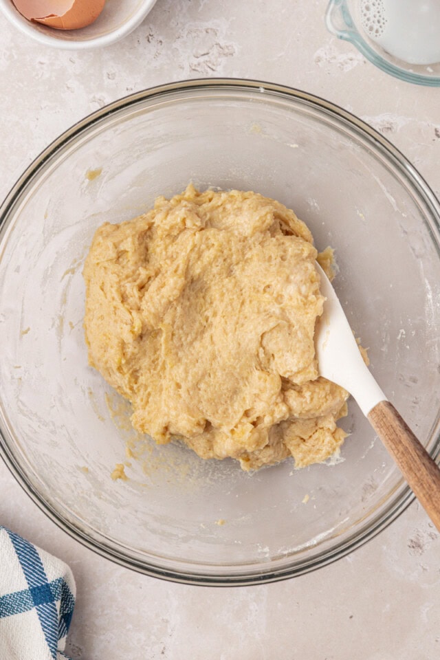 overhead view of yeast bread dough in a mixing bowl