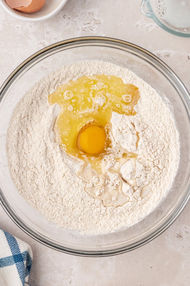 overhead view of egg added to flour mixture
