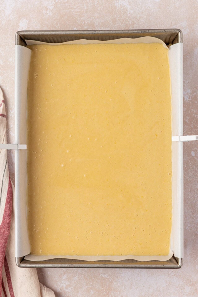 overhead view of hot milk cake batter in a 9x13 pan ready to go into the oven