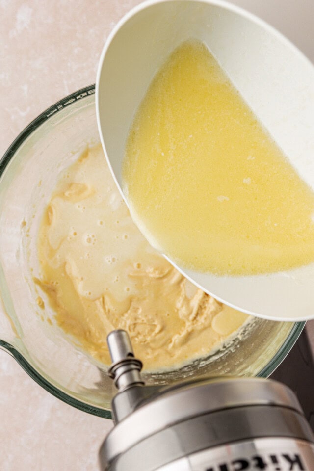 overhead view of hot milk mixture being added to cake batter