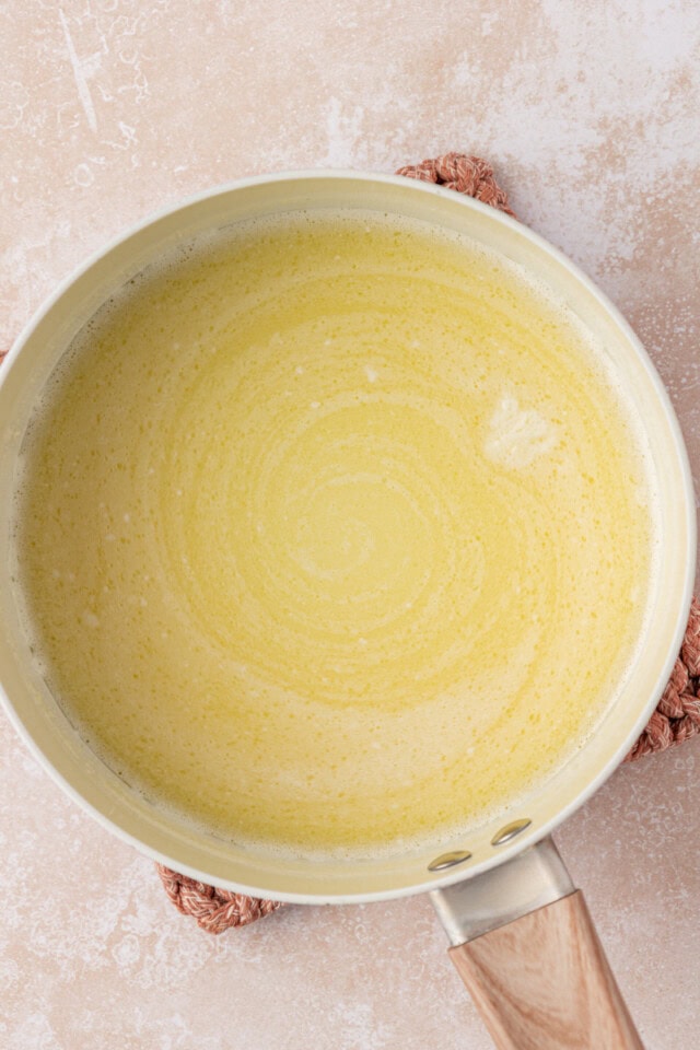 overhead view of heated milk and butter in a saucepn