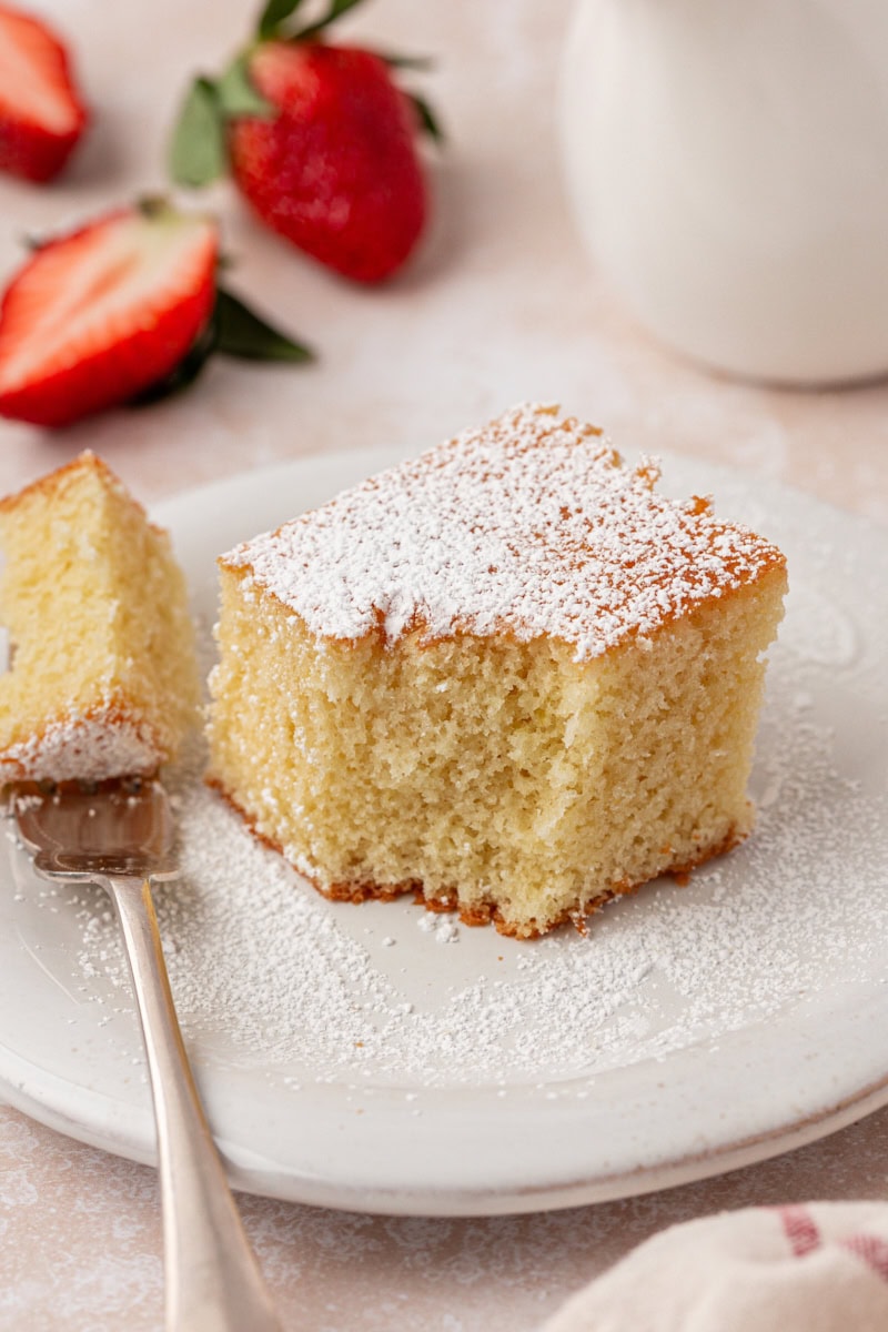 a slice of hot milk cake with a bite of cake on a fork