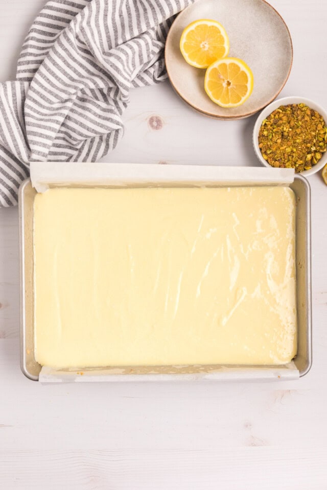 overhead view of lemon cheesecake filling poured on top of shortbread crust in a 9x13 pan