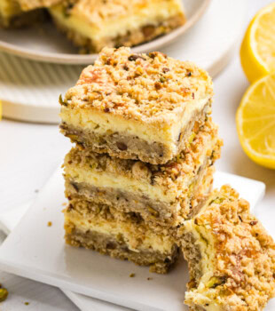 stack of three lemon pistachio cheesecake bars