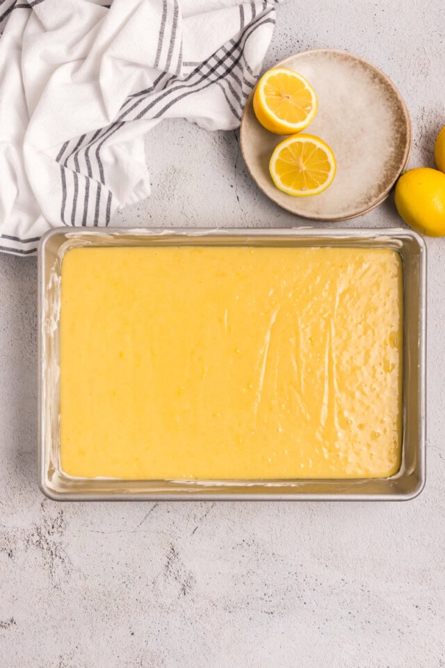 lemon pound cake batter in a 9x13 pan ready to go into the oven