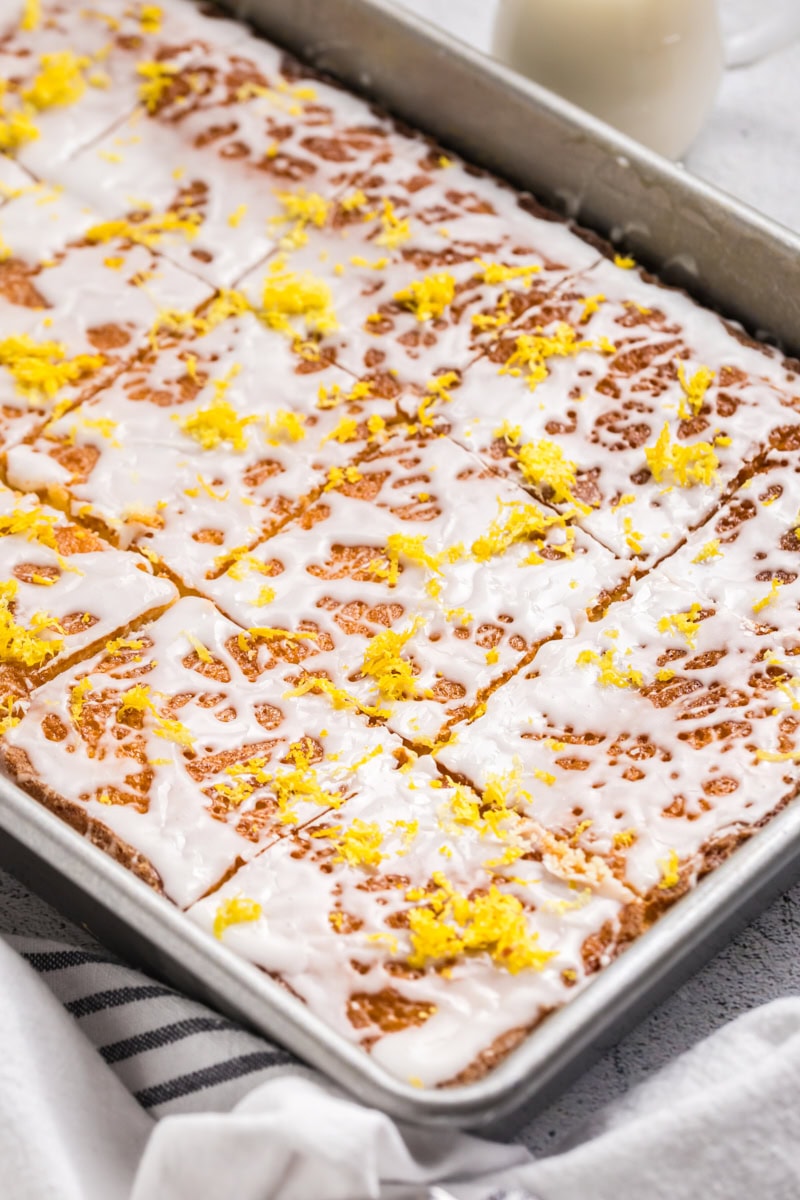 lemon pound cake bars topped with a lemony glaze and lemon zest