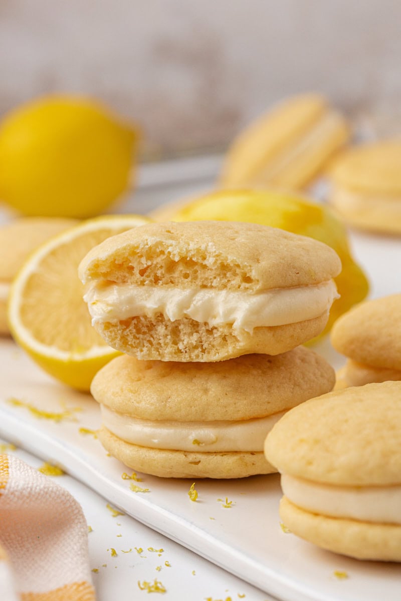 a lemon whoopie pie with a bite missing to show the creamy lemon filling