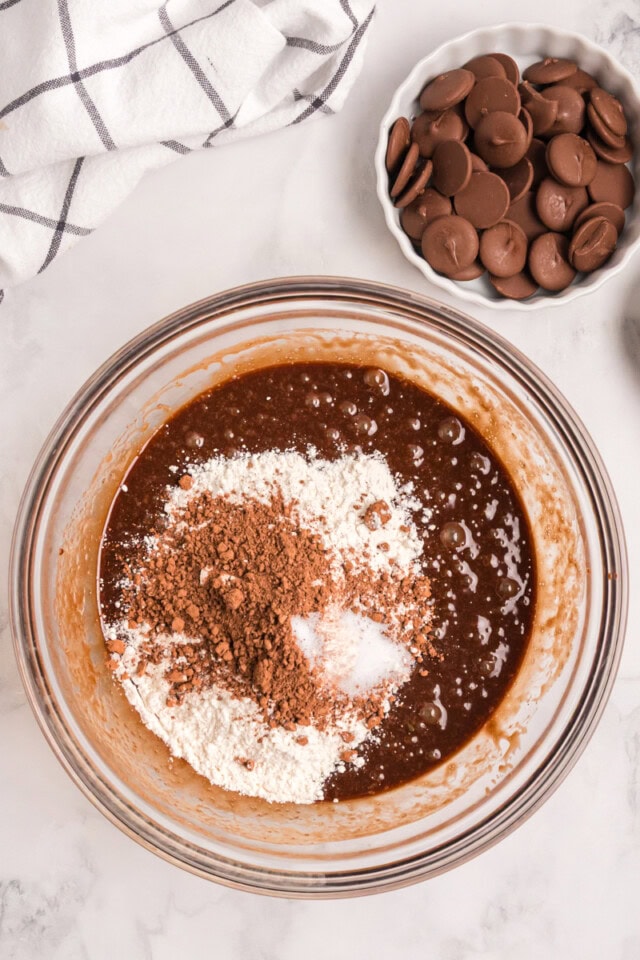 overhead view of flour, cocoa powder, and salt added to brownie batter
