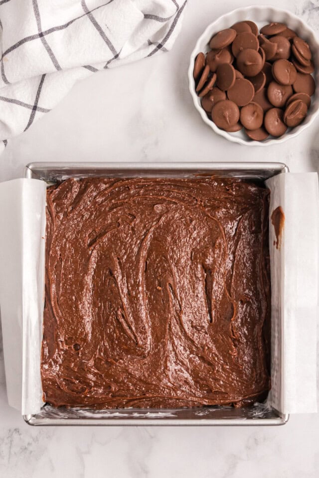 overhead view of brownie batter spread in a square baking pan