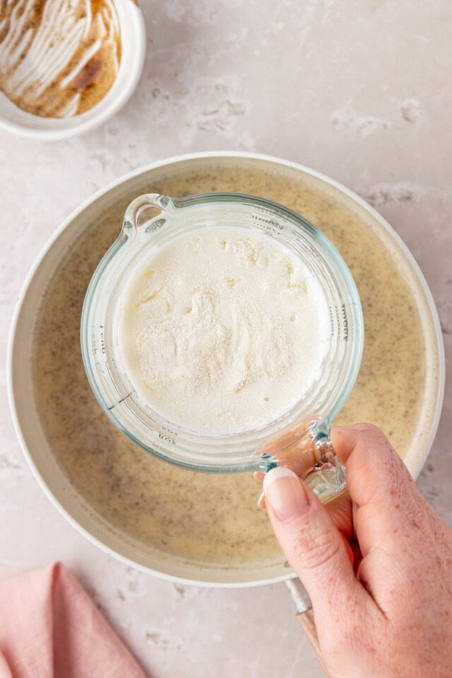 overhead view of gelatin bloomed in milk in a measuring cup