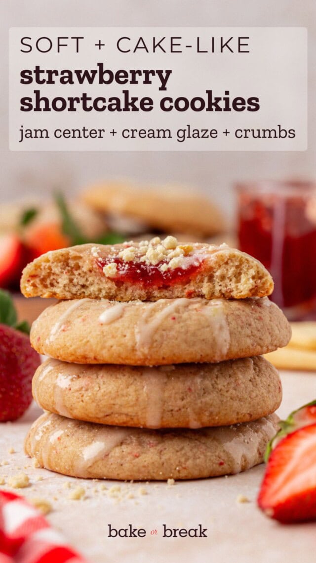 stack of strawberry shortcake cookies with the top cookie cut in half to show the jam filling; text overlay "soft + cake-like strawberry shortcake cookies - jam center + cream glaze + crumbs - bake or break"