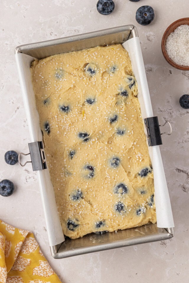 overhead view of blueberry ricotta cake in a loaf pan ready to go into the oven