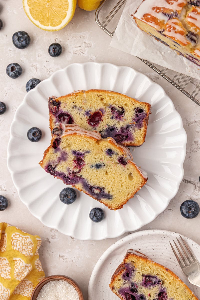 overhead view of two slices of blueberry ricotta loaf cake on a plate