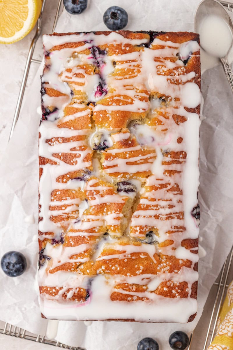 overhead view of blueberry ricotta loaf cake topped with a lemon glaze