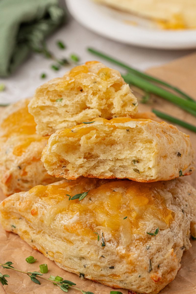 an herb and cheese scone torn in half to show the flaky texture