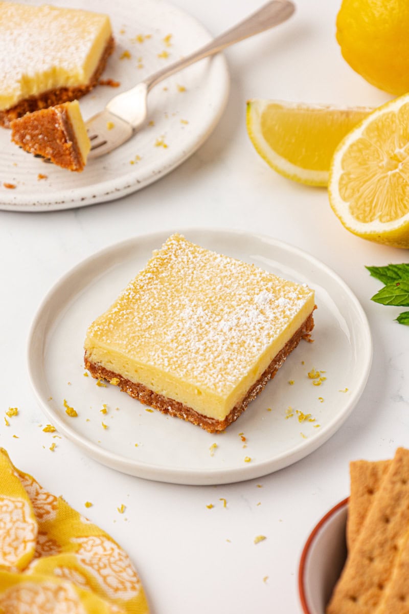 a lemon icebox bar topped with a sprinkle of powdered sugar