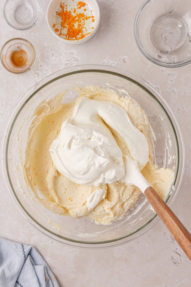whipped cream folding into no-bake cheesecake mixture