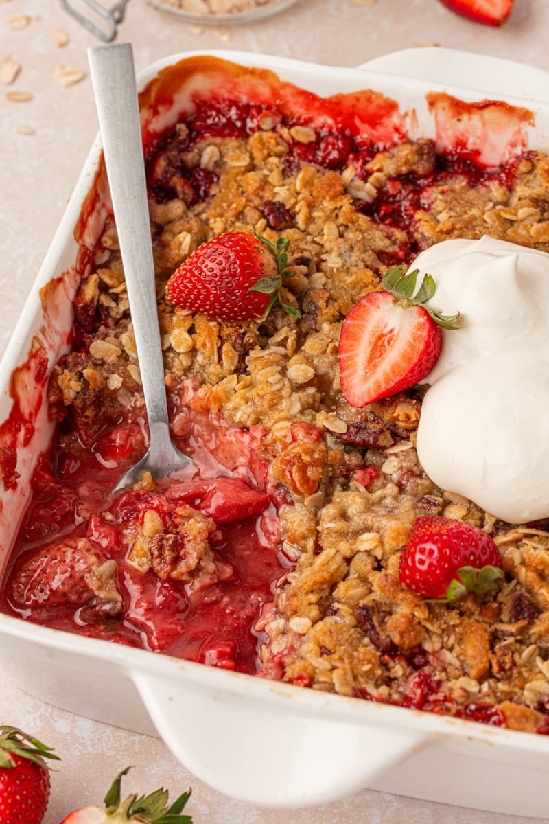 strawberry crisp with nutty oat topping in a baking dish
