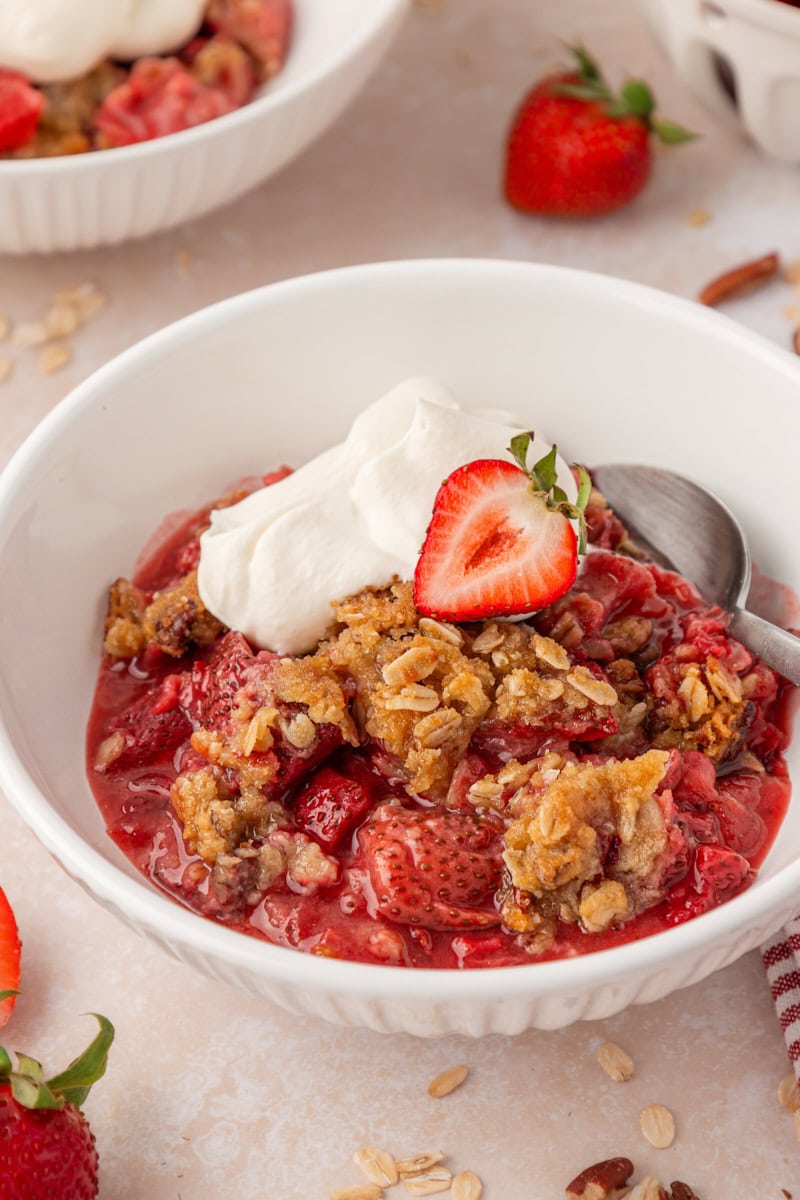 strawberry crisp with a nutty oat topping served in a white bowl