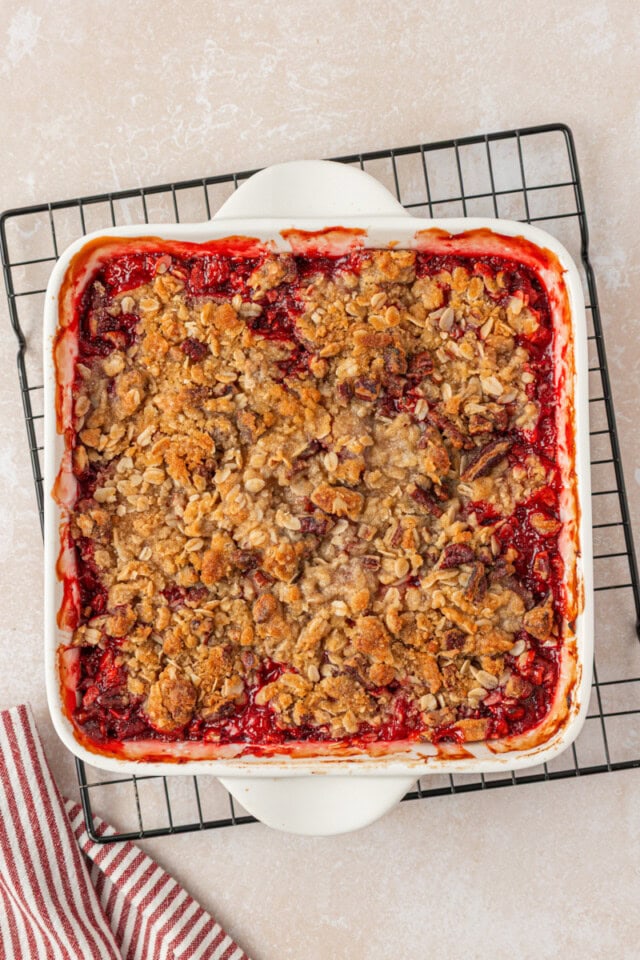 freshly baked strawberry crisp in a baking pan on a wire rack