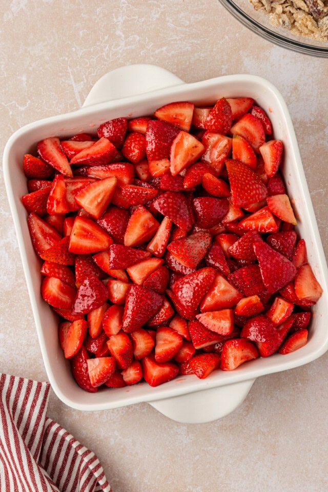 strawberry crisp filling mixture in a baking pan