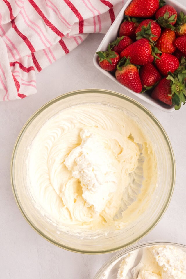 overhead view of whipped cream added to no-bake cheesecake mixture